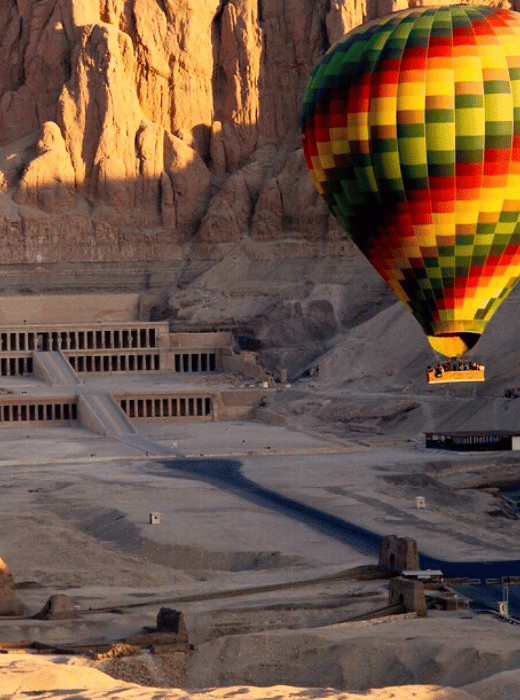 Hot air balloon floating over Luxor's historic landscapes, showcasing the expertise of the premium DMC Egypt.