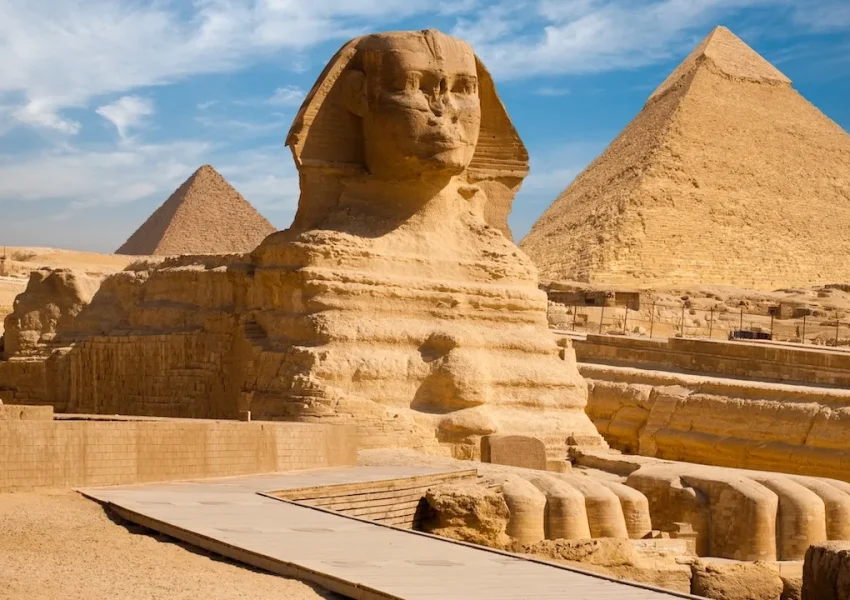 Sphinx and Pyramids in Giza, Egypt under clear sky.